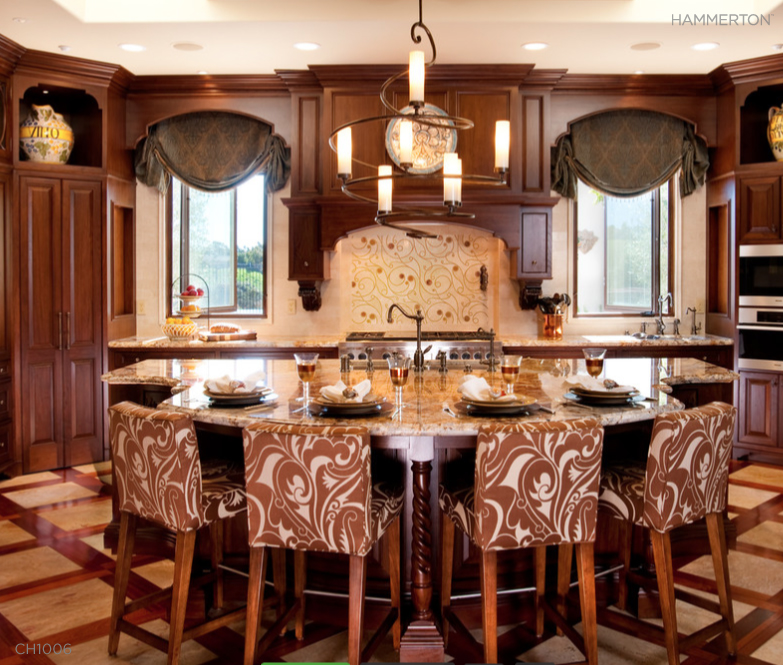 Whimsical scrolls in a kitchen backsplash and island seating are echoed in a CH1006 fixture from the Hammerton Seriph collection. interior design by R. Johnston Interiors.
