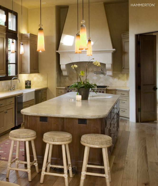 Elegant custom blown pendants in edge-wrapped Sea Tide glass add subtle drama to this European-inspired California kitchen. Interiors by Staprans Design.