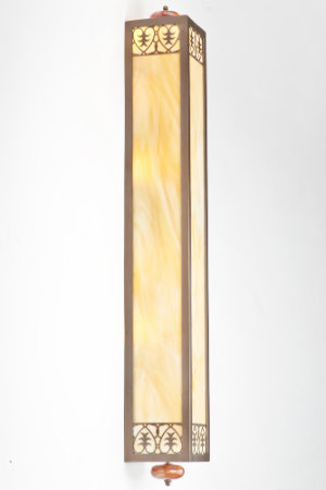 With its dramatic shape and stately lines, this custom fixture's architectural form -- featuring laser cut details with an art glass diffuser, blown glass finials and an antique copper finish -- can gracefully direct the eyes.