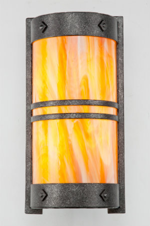 Swirling colors of slumped art glass and a stippled antique iron finish form an eclectic cover sconce that can make a bold statement in any transitional space.