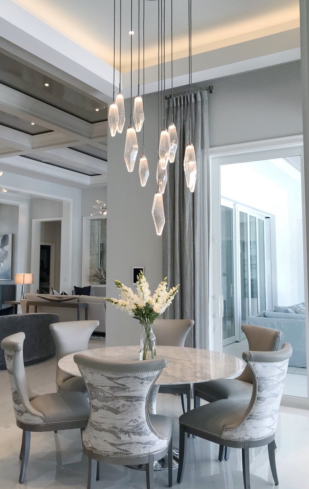 A Hammerton Studio Rock Crystal round multi-pendant strikes the perfect balance between traditional and modern in this cozy dining nook by Soco Interiors | Florida, New York, Ohio, Jackson Hole