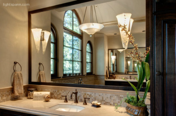Two contemporary wall sconces and a central chandelier