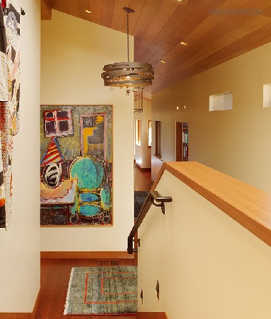 Colored blown glass balls amidst a swirling cyclone of steel add a whimsical accent to an otherwise understated stairway.