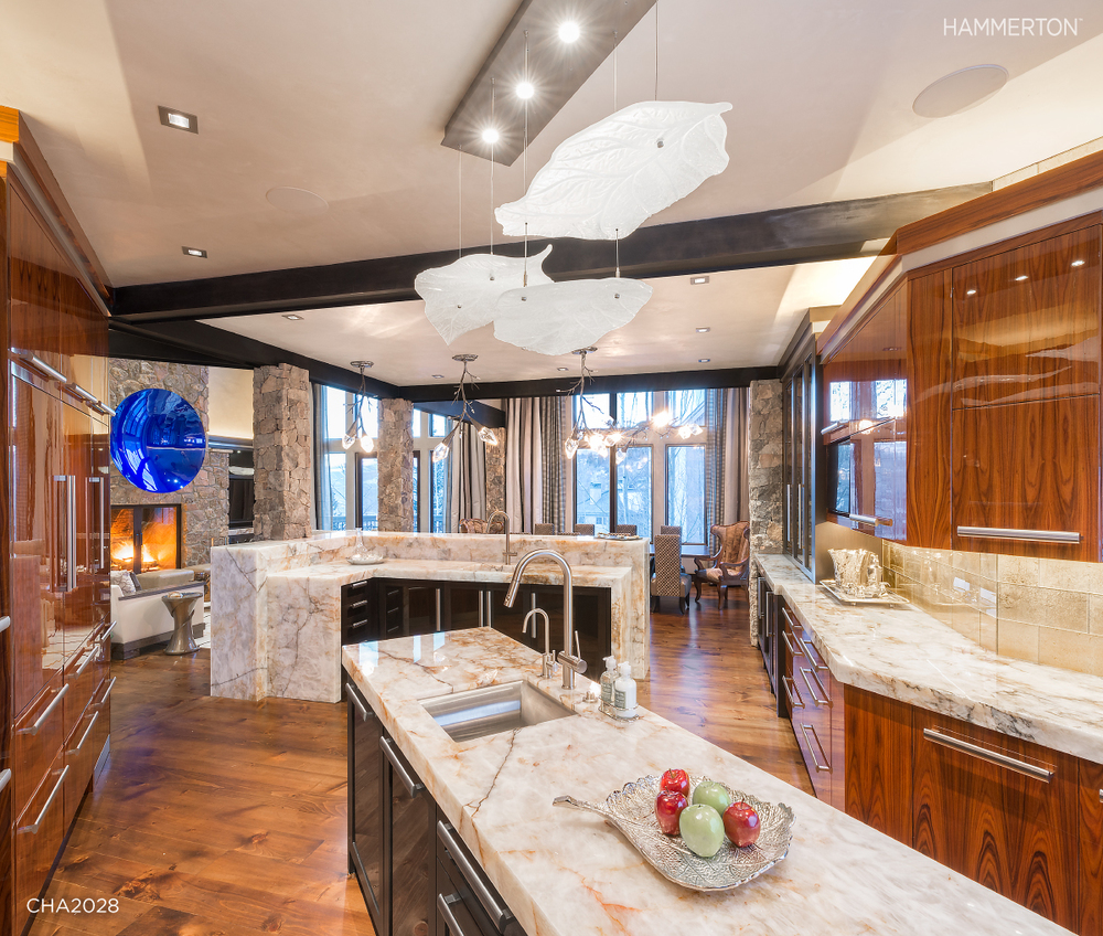  Floating leaves of sculpted kiln glass in a Lightspann CHA2028 fixture illuminate this kitchen bar. Interiors by AP Resort Concepts. 