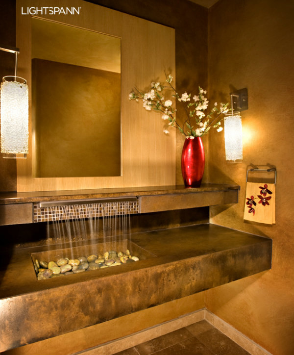  These stunning Rain Mosaic sconces from the Lightspann collection feature the smooth pebbled texture of tumbled 'stones', offering a delightful contrast to the sharp lines and rectangular planes in this contemporary powder room. 