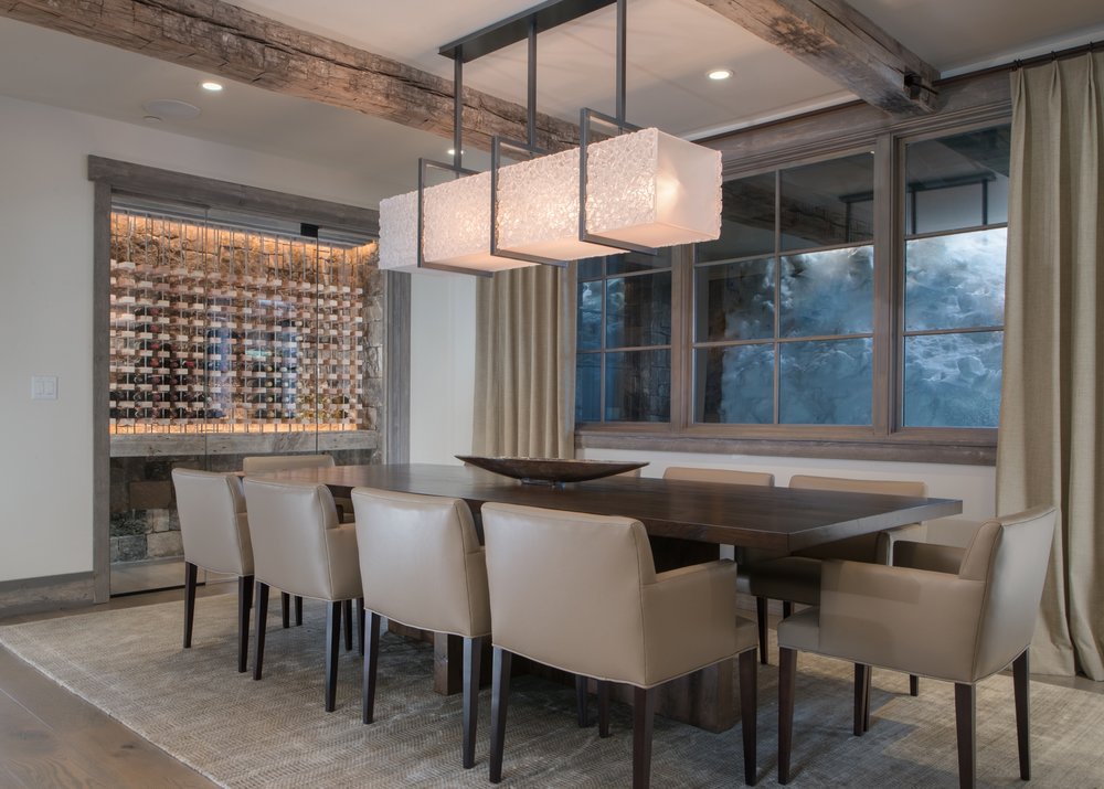 A glistening custom Hammerton dining light in artisan fused glass hangs in the dining room of this contemporary mountain home by KAM Designs . See this entire project in our Shooting Star residential case study >