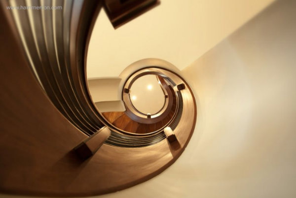 The home's breathtaking focal point is this graciously curved mahogany staircase and floating railing.