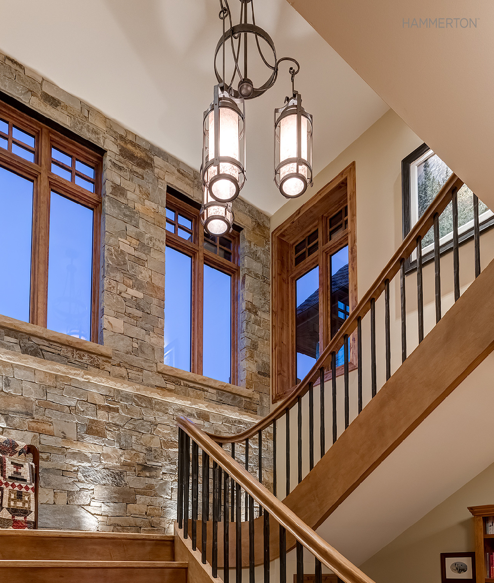 A Chateau pendant chandelier brings European flair to this old-world staircase.