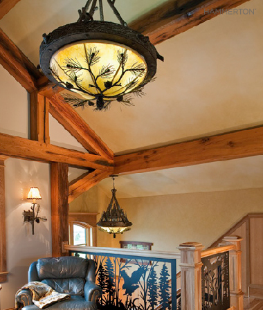 Two pine bough-laden Log & Timber dome lights nod to this stairwell's nature-inspired silhouette.