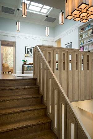 This upper level study features a custom Hammerton chandelier and a series of contemporary pendant lights that beautifully echo the stairway railing and skylight. 