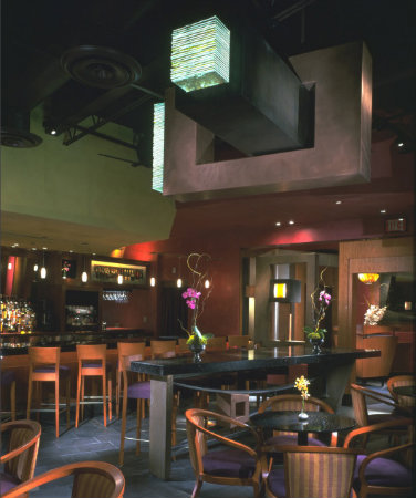 This one-of-a-kind architectural fixture also doubles as a large-scale sculpture that strategically draws the eye upwards in this restaurant space.