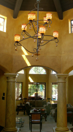 In this swirling Lightspann chandelier, a combination of blown Venetian glass shades and decorative glass spheres add an eclectic touch.