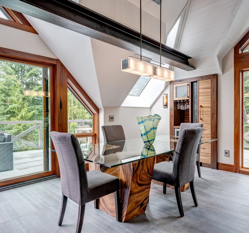 A Hammerton Studio Urban Loft Trestle linear suspension adds an artistic flair to this modern space.